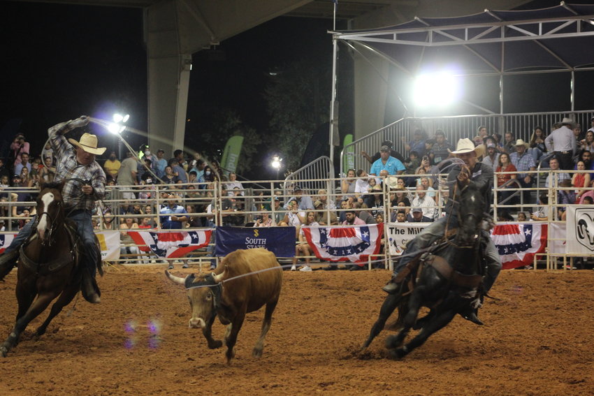 A pair of contestants in team roping competition.