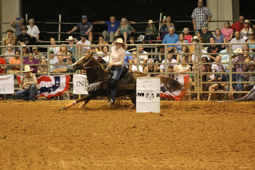 PRCA Indiantown Rodeo featured cowgirls racing against the clock and other contestants while shaving tenths of seconds from scoreboard leaders, aimed at winning.