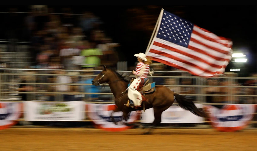 The American flag racing around the Timer Powers Park arena during the 74th annual Indiantown PRCA rodeo, Oct. 15 2021.