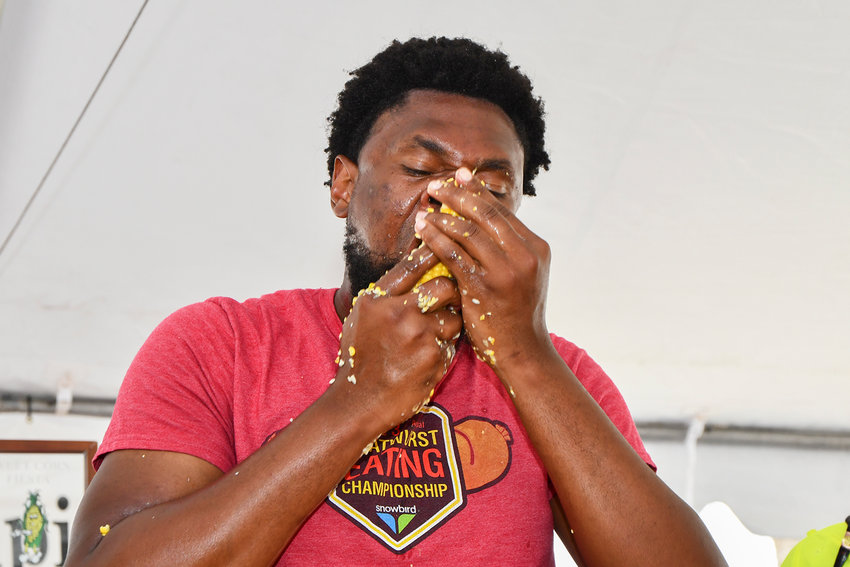 Professional eater Gideon Oji shows his style of eating corn during the National Sweet Corn Eating Championship.