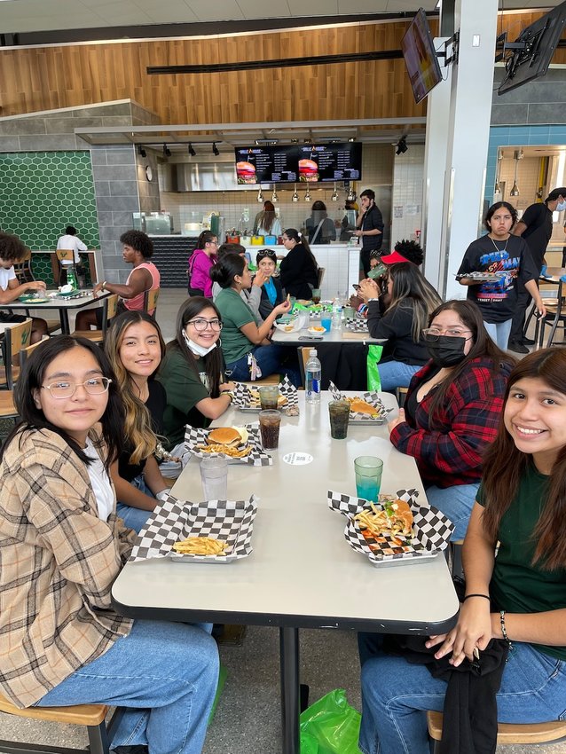Crystal C., Karen V., Vanessa H., Julianna R., and Alexis V. eat lunch at a University of South Florida dining hall.