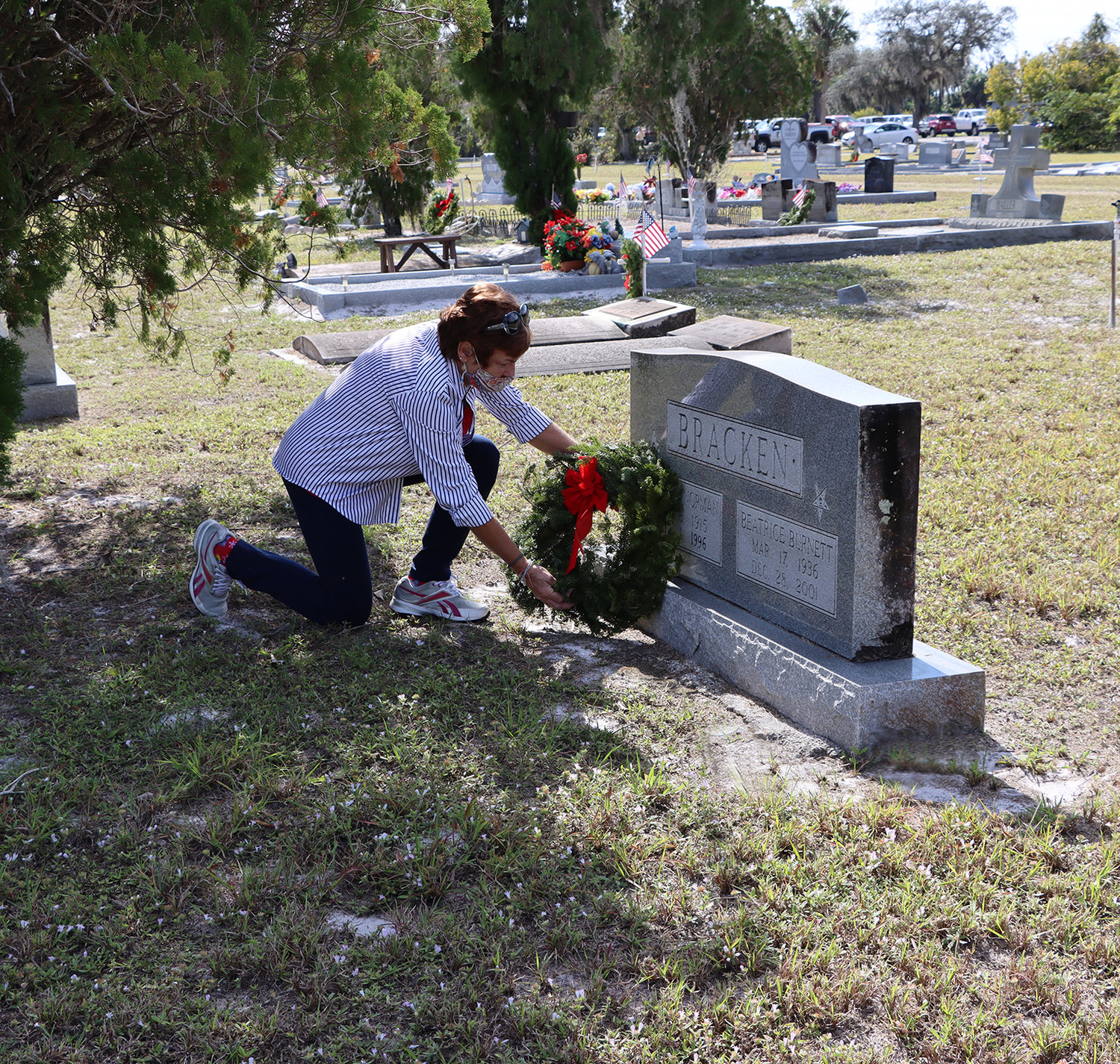 April Beavers lays a wreath at the grave of one of the 365 Veterans in the Ortona Cemetery.