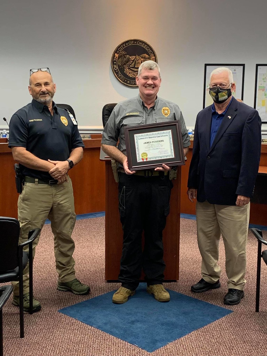 Mayor Watford (right) and Police Chief Peterson (left) present a 15-Year Longevity Service Award to Detective James Pickering at the March 2, 2021 City Council meeting.