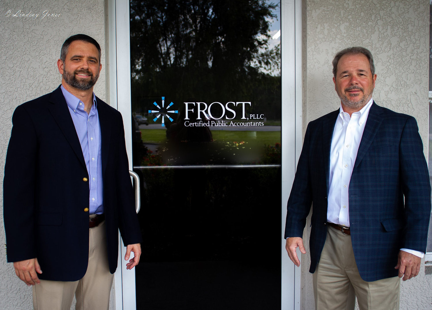 Andrew Jones and Doug Richardson stand outside Frost, PLLC.