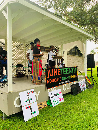 Speakers took the stage, adorned with signs, for the first-ever Hendry County Juneteenth Celebration in Clewiston’s Civic Park.