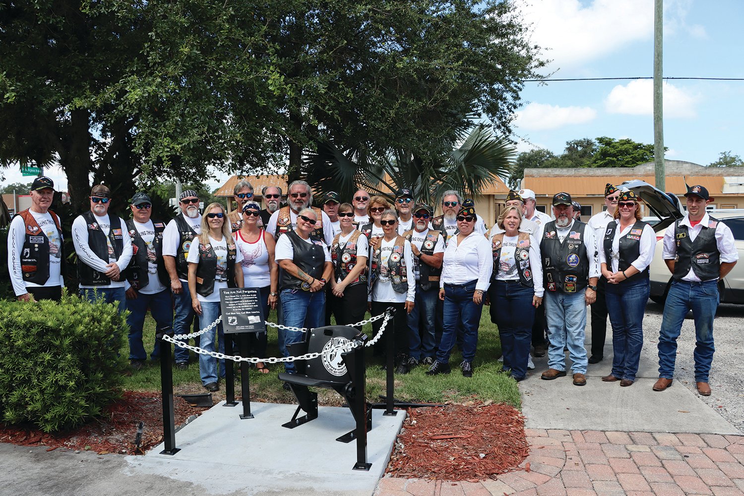 Members of Rolling Thunder®, Inc. Chapter 5 Florida out of Naples, American Legion #130 and VFW #10100 out of LaBelle standing behind the newly unveiled Chair of Honor at the LaBelle Veteran's Park.