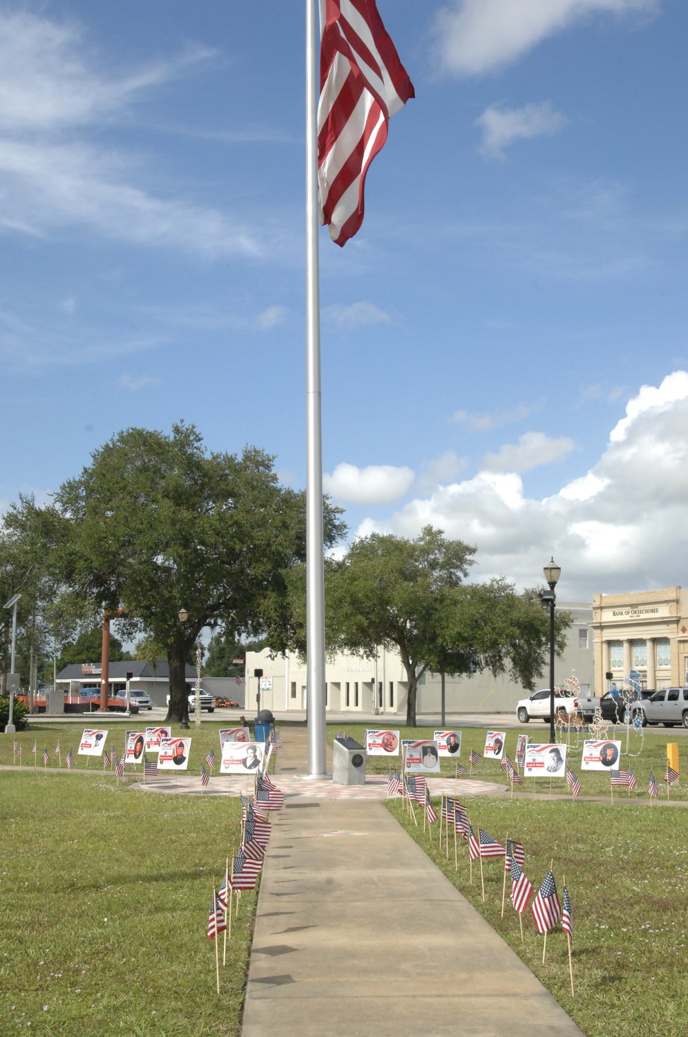 Around the flagpole in Park 4 of Flagler Park, signs honor local veterans.