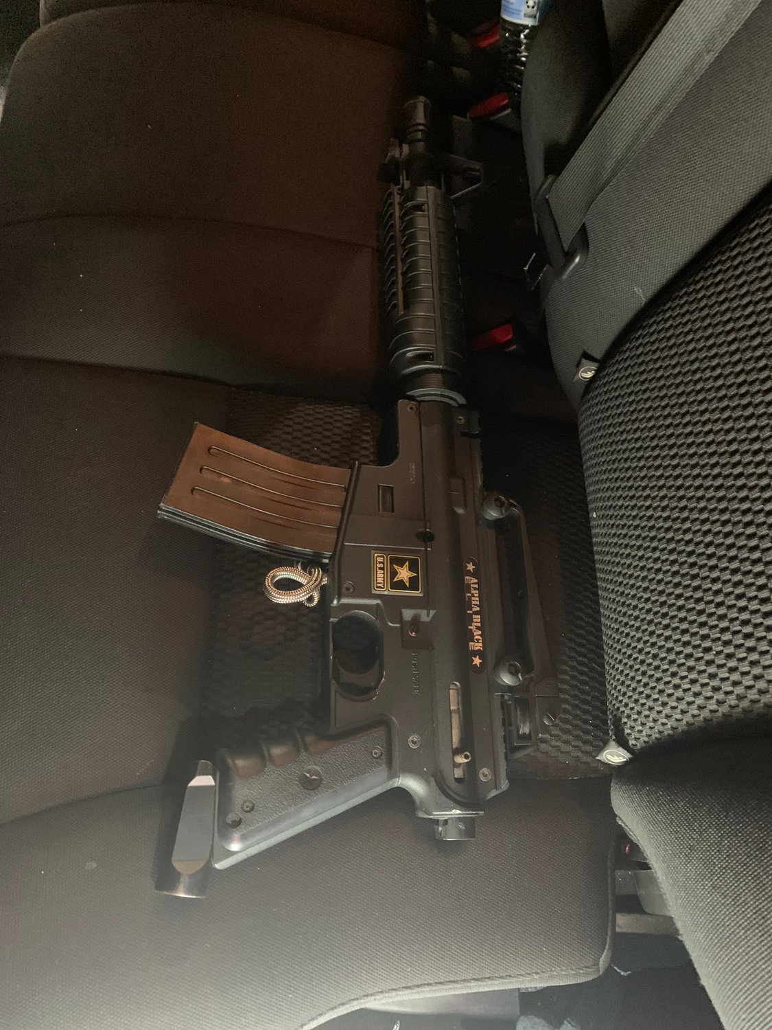 A modified paintball gun, styled as an AR-15 rifle, was found in the back seat of the suspect's vehicle by police Dec. 1.