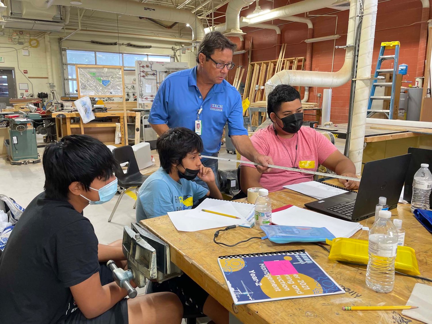 Students from the Engineering & Construction Management Pathway participate in an activity with an Immokalee Technical College (iTECH) professional as part of their second year in the program.