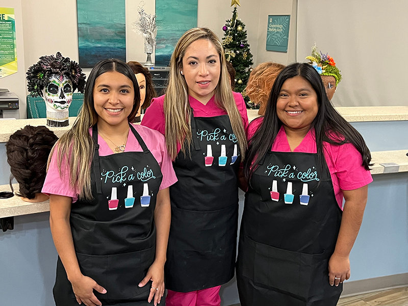 At PBSC's Belle Glade campus salon lab, Nails Technician students (from left) Guadalupe Ruiz, Maya Vallejo, and Jessica Riquiz celebrate their Dress for Success scholarships.