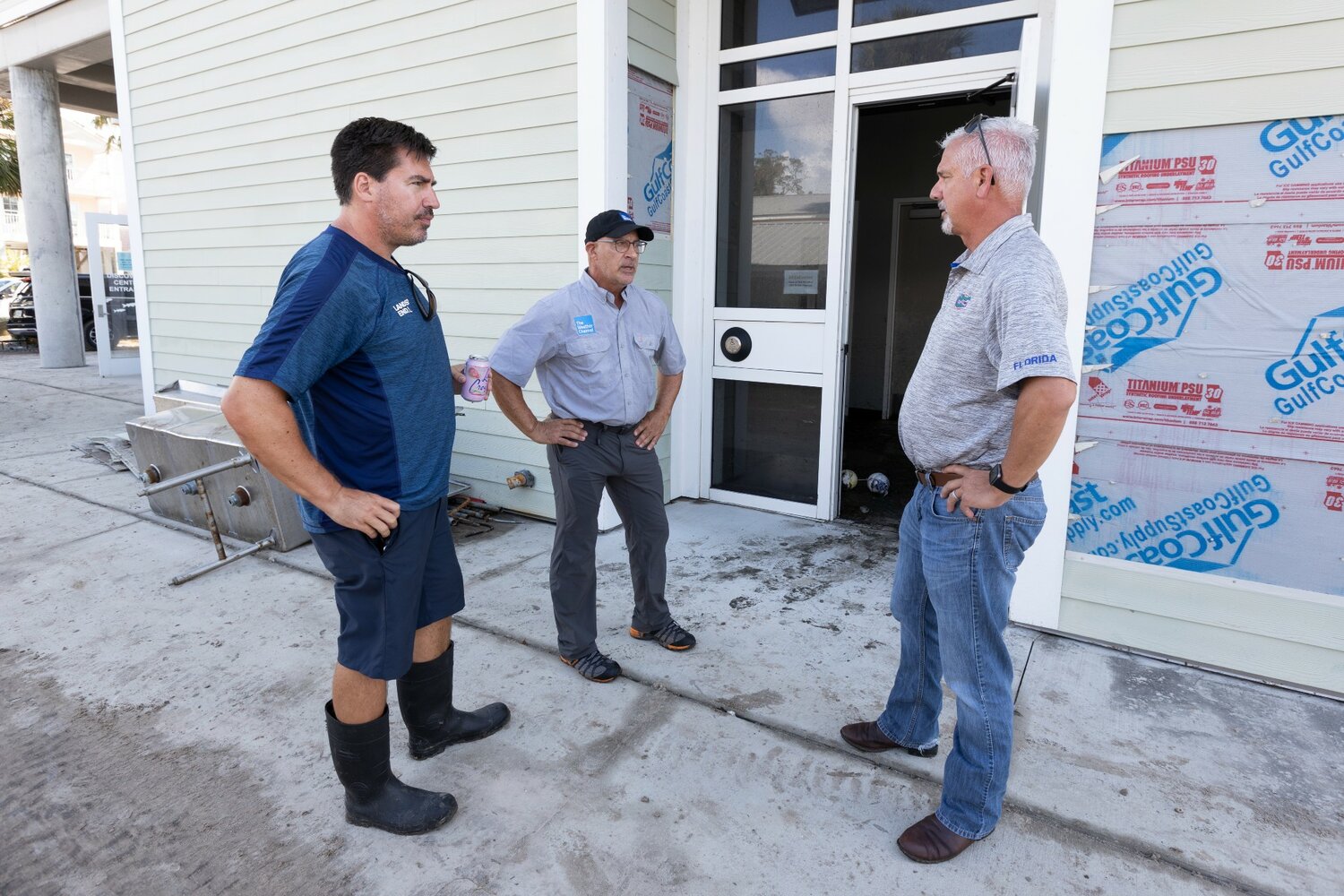 Jim Cantore, center, talks with UF/IFAS personnel during a cleanup of Cedar Key.