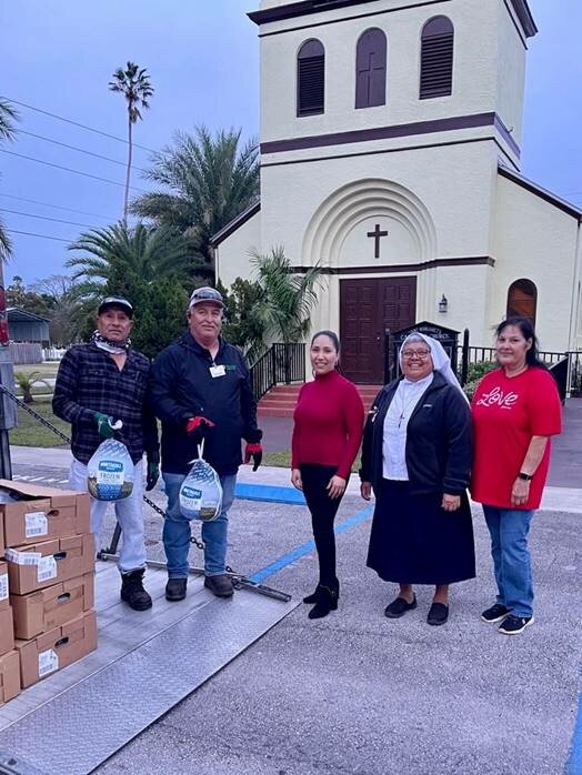 U.S. Sugar employees with staff at St. Margaret’s Catholic Church in Clewiston.